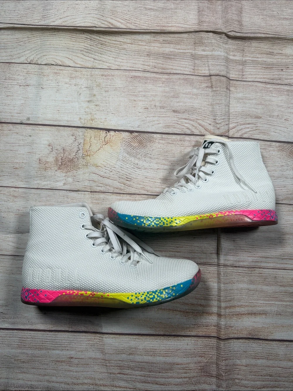NOBULL‎ white high-top trainers featuring a vibrant multi-color glitch sole